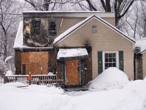 Aftermath of House burned in fire in winter.