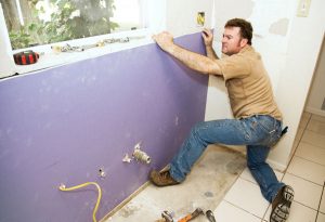 Worker Installing Drywall